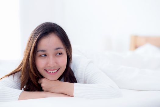 woman beautiful smiling woman portrait wake up early morning after sleeping and lying in bed.