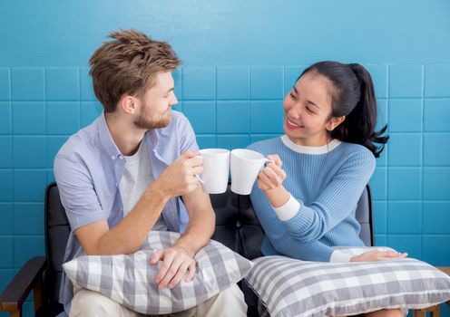 Two people couple in living room enjoy with drink coffee with success.