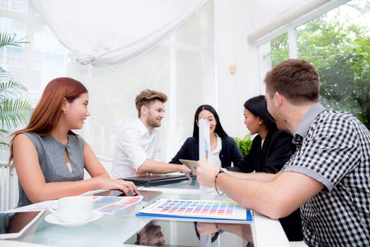 Group of business people brainstorming together in the meeting room.