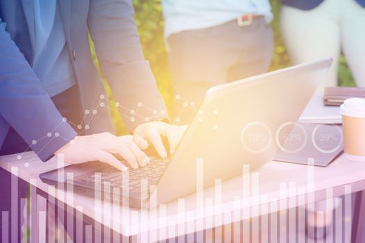 Business economic and technology working concept. Woman hand using notebook double exposure graph money stock trading finance concept.