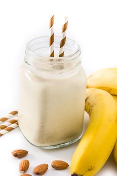 Banana smoothie with almond in jar isolated on white background
