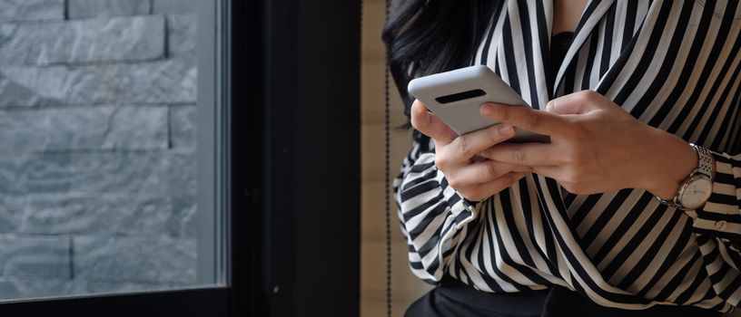 Asian woman using smartphone for social network.