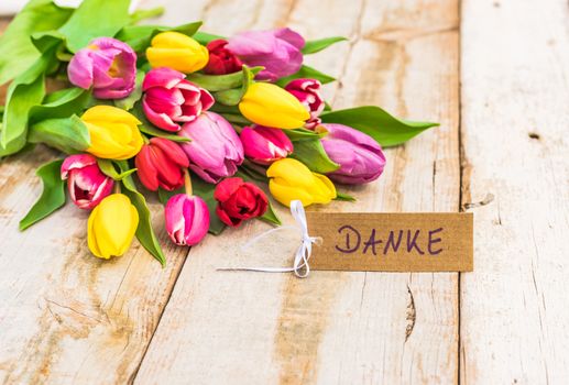 Colorful bouquet of flowers and label with german text, Danke, means thank you