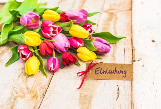 Beautiful bouquet of flowers and label with german word, Einladung, means invitation