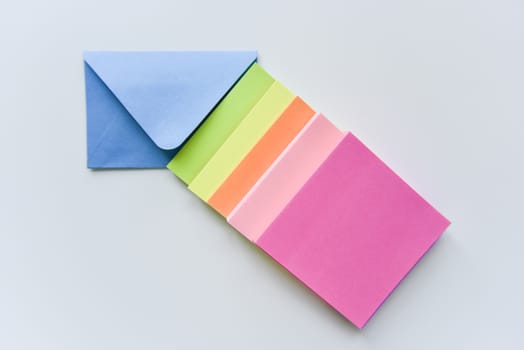 selective focus, blue envelope in the center with bright colored rectangles directed towards the corner