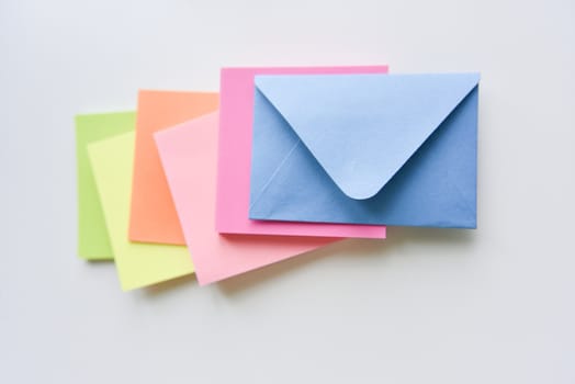 selective focus, blue envelope in the center with bright colored rectangles spreading under it