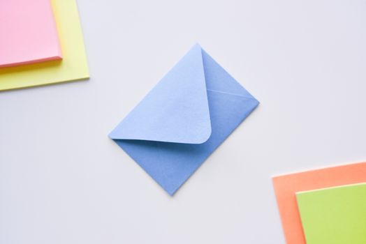 selective focus, blue envelope in the center with bright colored rectangles in corners