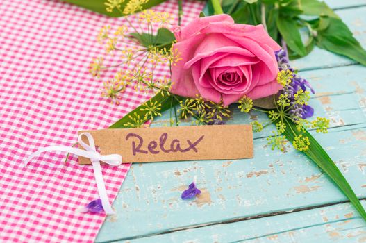 Romantic bunch of rose flower and card with the word Relax