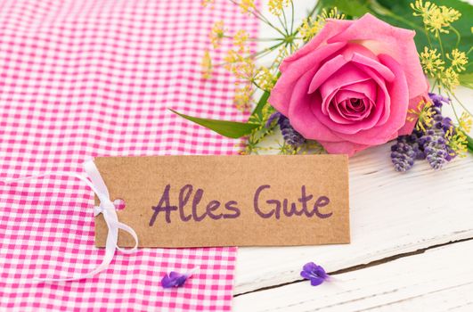Romantic bunch of flowers and greeting card with german text, Alles Gute, means best whishes