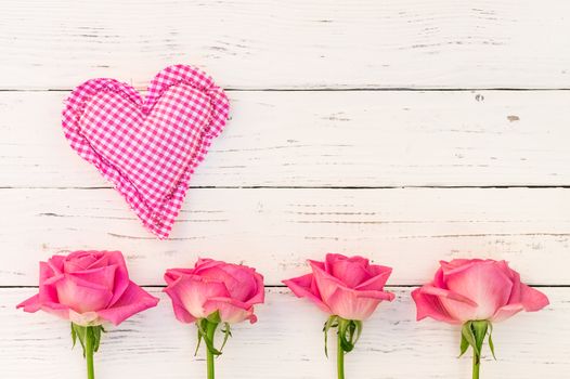 Romantic heart with pink roses on white wooden background for Mother's day