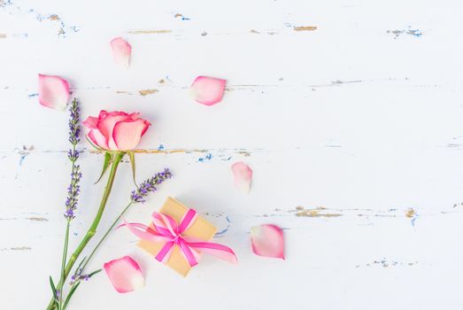 Romantic flowers and present on white background with copy space