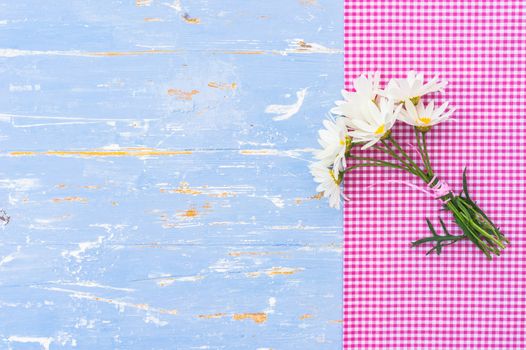 Romantic flowers background for Mothers day on blue wood with copy space