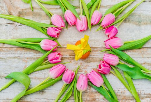 Easter greeting card with pink tulip flowers and easter egg decoration