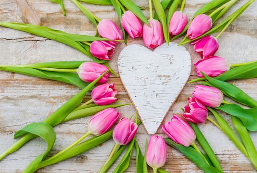 Heart shape with pink tulip flowers and white love heart