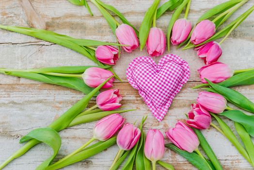 Love background with pink heart and tulip flowers