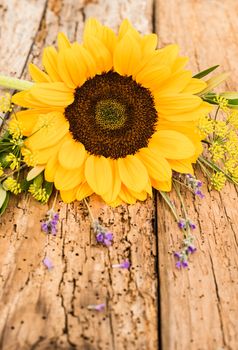 Beautiful flower arrangement of yellow sunflower on rustic wooden background