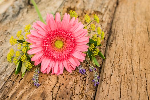 Pink gerbera daisy arrangement on old wooden background