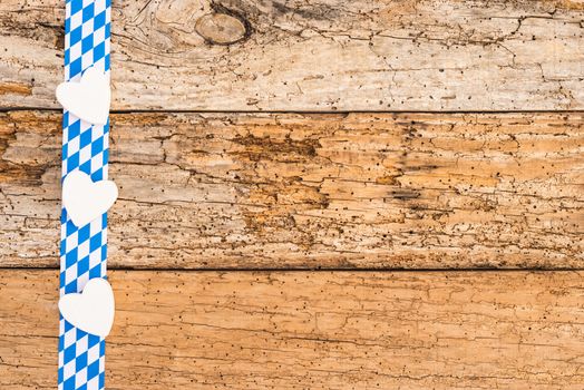 Oktoberfest background decoration on rustic wood with blue white bavarian pattern