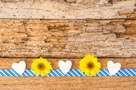 Rustic background for Oktoberfest with traditional blue white pattern, flowers and hearts
