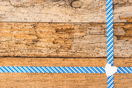 Old wooden background for Oktoberfest with traditional bavarian pattern, heart and copy space