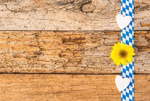 Rustic background for Oktoberfest Germany with bavarian pattern, hearts and flower