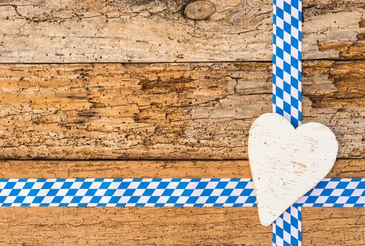 Rustic wood background with heart and bavarian pattern for Oktoberfest