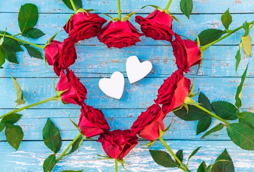 Romantic love background with heart shape of red roses and two love hearts