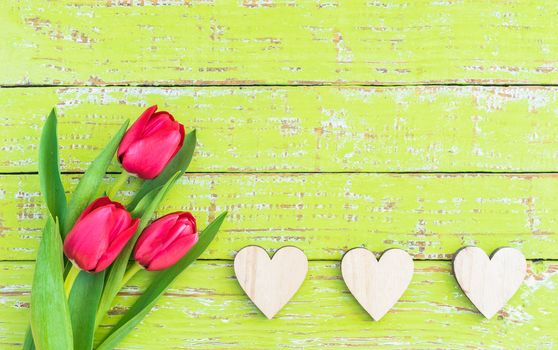 Romantic Mothers day background with fresh tulip flowers and hearts border