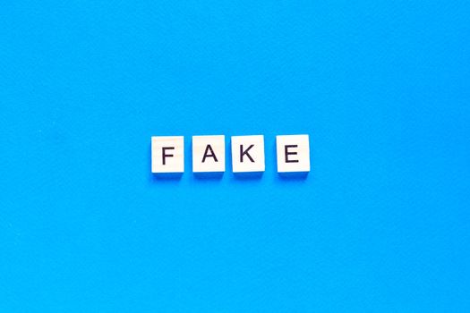 Fake word alphabet letters on blue background. flat layout. top view.