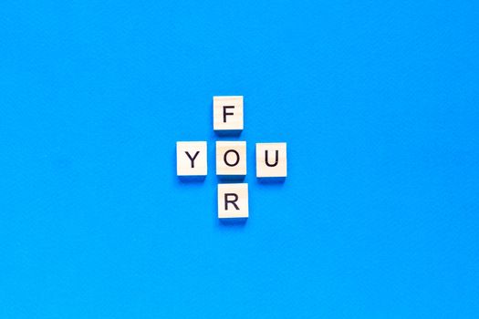 FOR YOU written in wooden letters on a blue background. top view, flat layout, I'll do anything for you