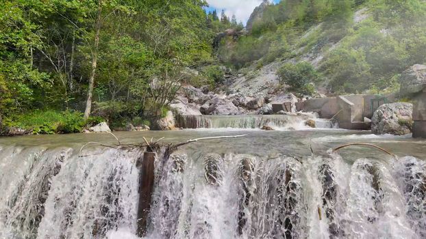 Beautiful mountain waterfalls as seen from a drone, alpin landscape