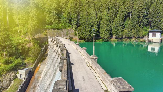 Alpin lake and dam in summertime, view from drone, Auronzo, italian dolomites.