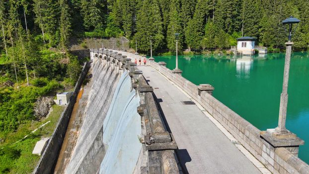 Alpin lake and dam in summertime, view from drone, Auronzo, italian dolomites.