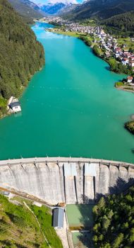 Alpin lake and dam in summertime, view from drone, Auronzo, italian dolomites.