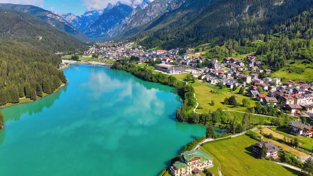 Aerial view of Auronzo Lake and Town in summertime, italian dolomites.