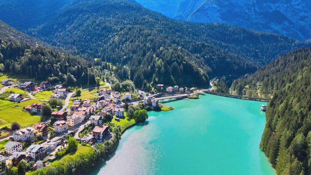 Alpin lake and dam in summertime, view from drone, Auronzo, italian dolomites.