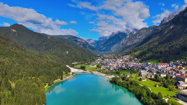 Aerial view of Auronzo Lake and Town in summertime, italian dolomites.