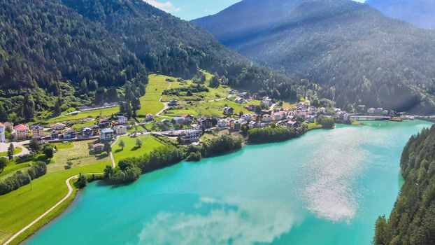 Aerial view of Auronzo Lake and Town in summertime, italian dolomites.