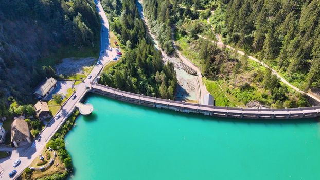 Alpin lake and dam in summertime, view from drone, Auronzo, italian dolomites.