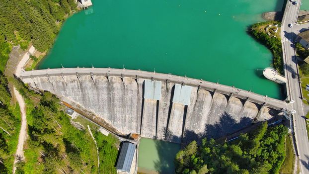 Alpin lake and dam in summertime, view from drone, Auronzo, italian dolomites.