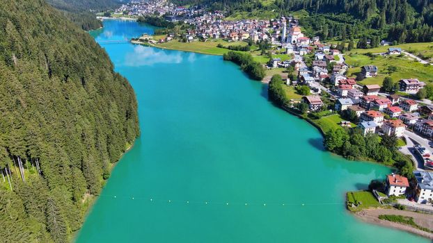 Alpin lake and dam in summertime, view from drone, Auronzo, italian dolomites.