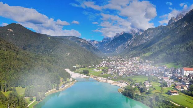 Aerial view of Auronzo Lake and Town in summertime, italian dolomites.