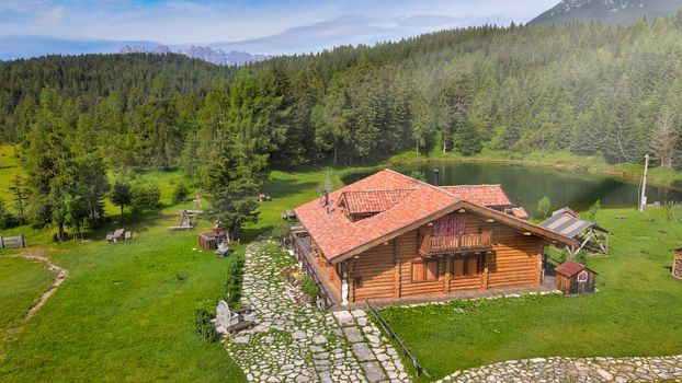 DANTA, ITALY - JULY 2020: Alpin restaurant over the lake in summer season, aerial view.