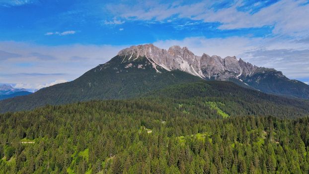 Aerial view of Auronzo Lake and Town in summertime, italian dolomites.