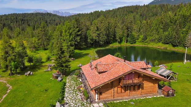 DANTA, ITALY - JULY 2020: Alpin restaurant over the lake in summer season, aerial view.