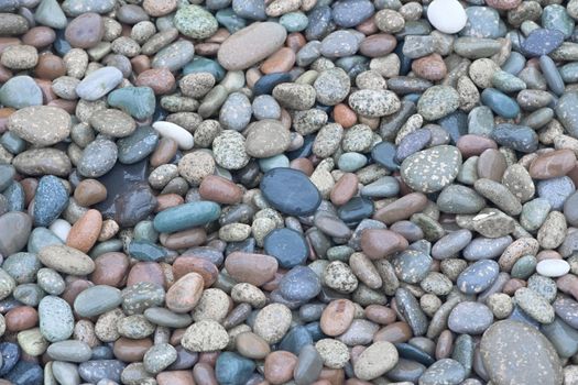 4 - Hundreds of bright wed red and blue colored pebbles create a simple and relaxing background. Smooth stones found on a beach.