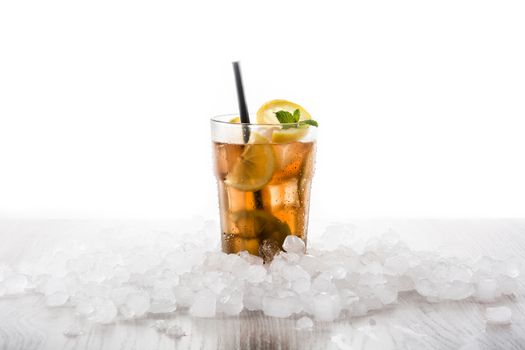Iced tea drink with lemon in glass isolated on white background