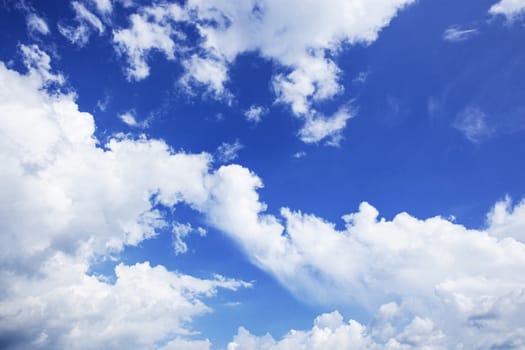 White clouds in the blue sky with background.