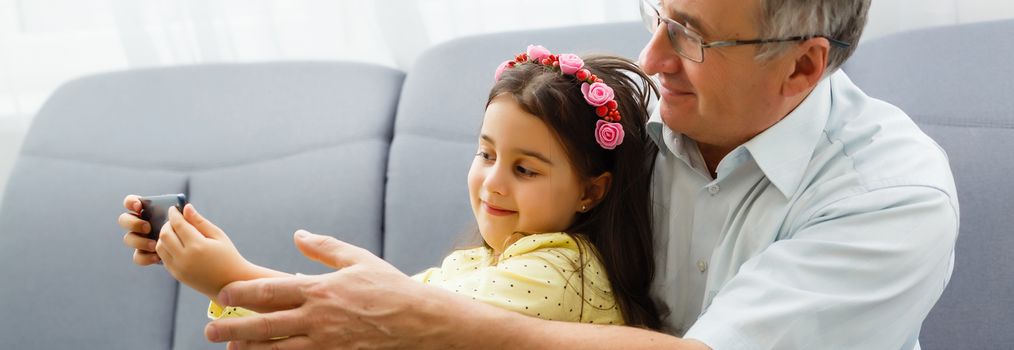 Grandfather and granddaughter make selfie