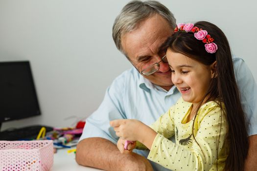 grandfather and granddaughter do her homework